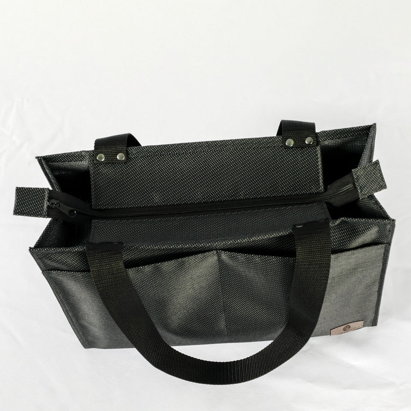 A black zippered shopper tote with.a black zipper and hardware 