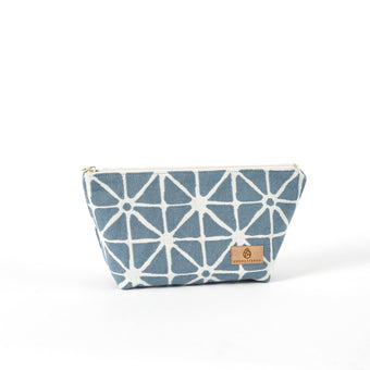 Blue geometric patterned makeup bag named Erin with a suede Unshattered label on a white background