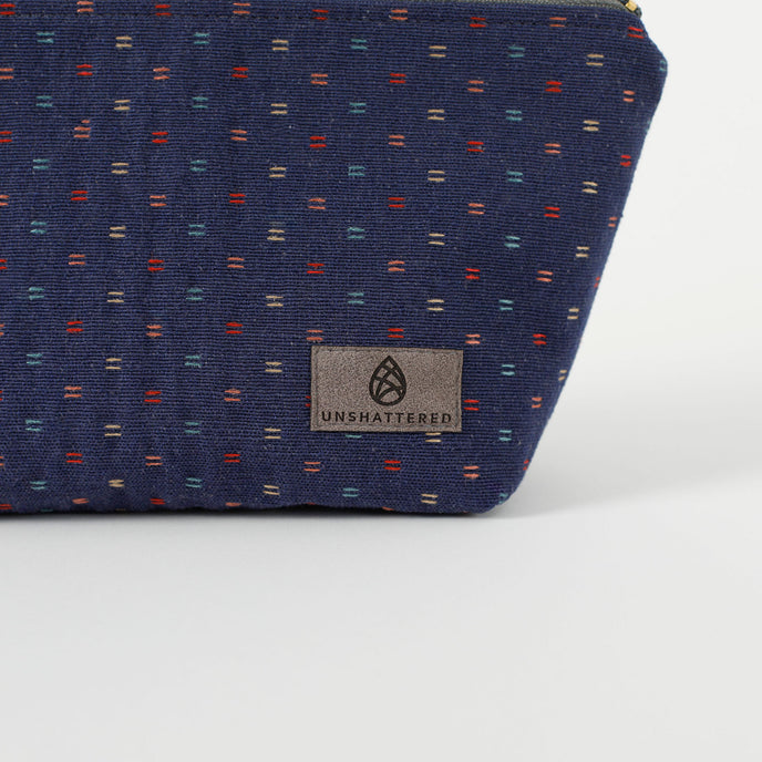 A gray label on a dark blue makeup kit with two lines design 