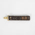 This brown fabric wristlet key clip features a playful dotted pattern and sleek gold-tone hardware.