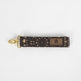 This brown fabric wristlet key clip features a playful dotted pattern and sleek gold-tone hardware.
