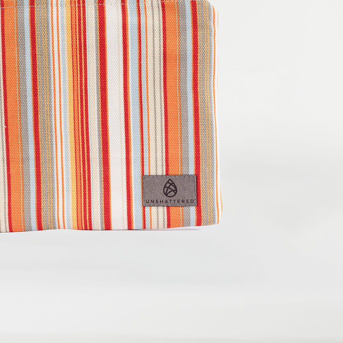 A gray label on a striped colorful large zip pouch named after Candy 