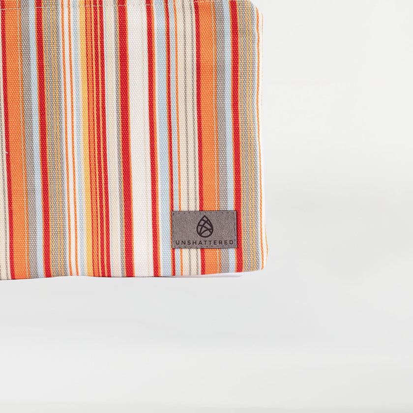 A gray label on a striped colorful large zip pouch named after Candy 
