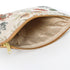 Floral-patterned pouch with a striped checkered interior with a gold zipper on a white background named after Cathy 