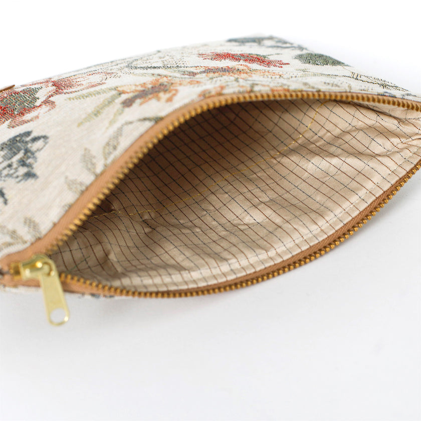 Floral-patterned pouch with a striped checkered interior with a gold zipper on a white background named after Cathy 