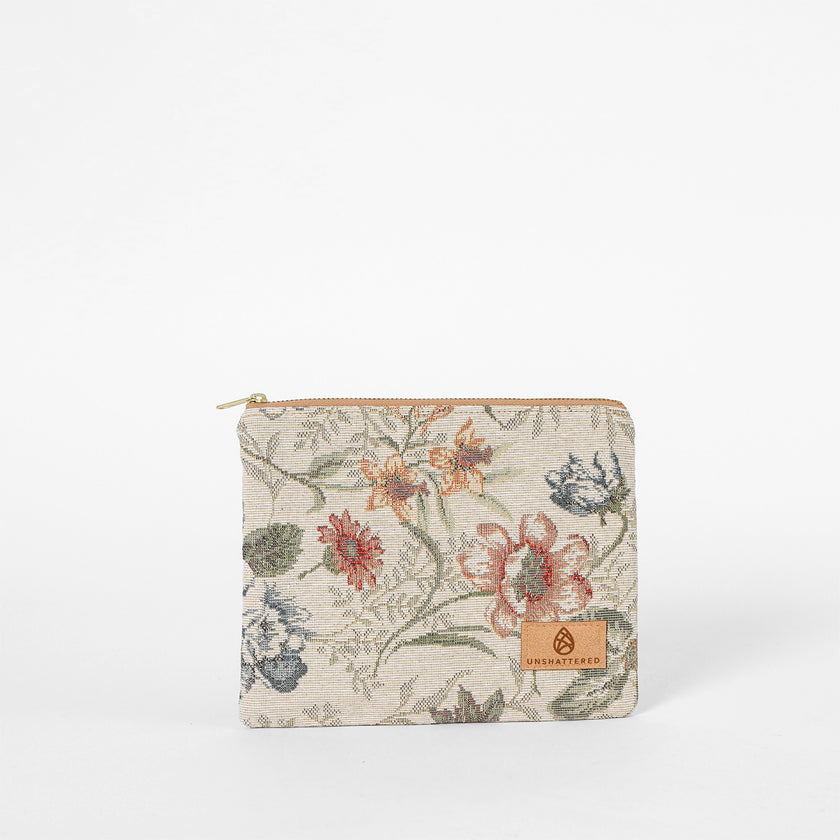 Floral-patterned pouch with a brand logo on a white background named after Cathy 