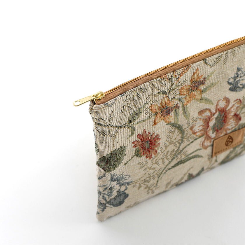 Floral-patterned pouch with a gold zipper on a white background named after Cathy 