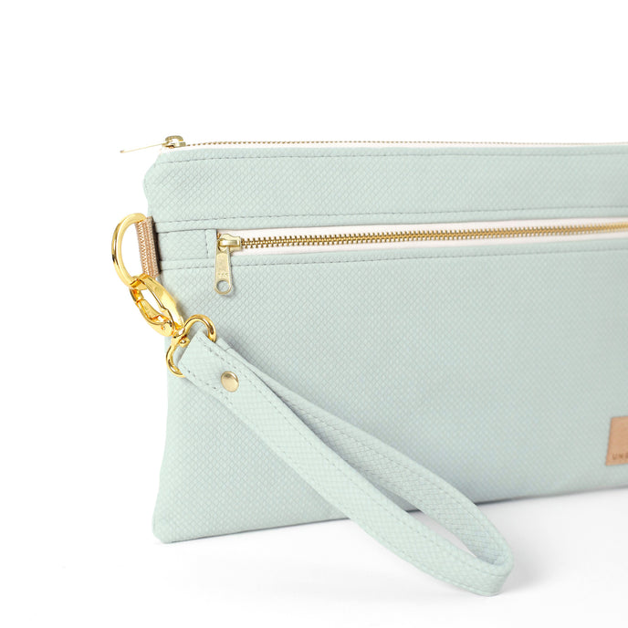 Close up of light blue wristlet strap on the George 3-in-1 Bag handcrafted from light blue wipe-clean material on a white background