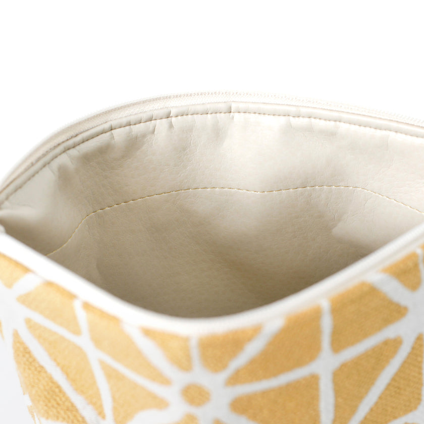 Close up of wipe-clean interior of the Isabel Makeup Bag handcrafted from yellow geometric patterned fabric