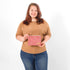 Woman holding a pink patterned pouch against a white background named after Dariene