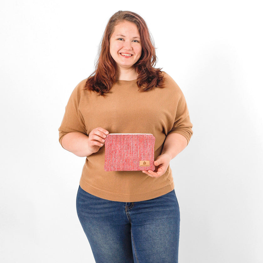 Woman holding a pink patterned pouch against a white background named after Dariene