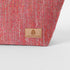 Pink  textured fabric with a tan label on a white background named after Dee