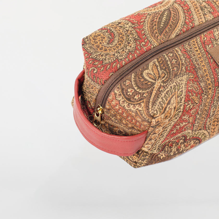 A red handle and gold zipper tone on paisley toiletry kit named after Destiny