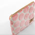 Pink dotted zippered pouch with gold zipper on a white background