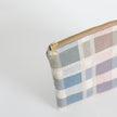 Plaid patterned pouch with gold zipper on a white  background named after Alyzaah 