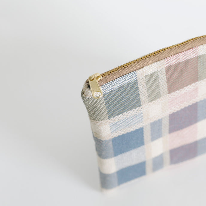 Plaid patterned pouch with gold zipper on a white  background named after Alyzaah 