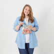 A woman holding a flower design zip pouch with a blue shirt and jeans  named after Diana