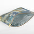 A blue fabric interior with a gold tone zipper on a multi-color sea glass design large zip pouch 
