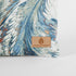 A detail shot of a tan Unshattered label in the bottom right corner of this Eliza Crossbody bag.