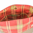 A red plaid tote interior with three pockets 