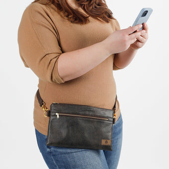 A woman handsfree wearing a brown Faith 3-in-1 bag with a zipper closure, gold-tone hardware, and three detachable straps