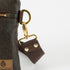 Close up of brown crossbody strap attached to brown 3-in-1 Bag