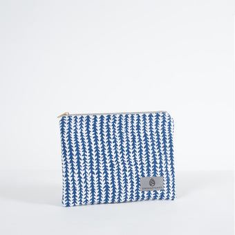 A blue and white pattern zip pouch with a gray Unshattered label on a white background 