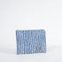 A blue and white pattern zip pouch with a gray Unshattered label on a white background 