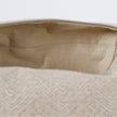 A cream luxury leather alternative material on the interior of this beige toiletry kit