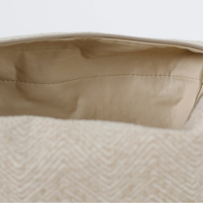 A cream luxury leather alternative material on the interior of this beige toiletry kit