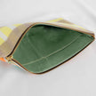 A green interior fabric on this tan, yellow and white design large zip pouch 