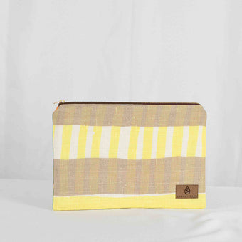 A large zip pouch with yellow and beige stripes and a small brand tag on the bottom right corner.