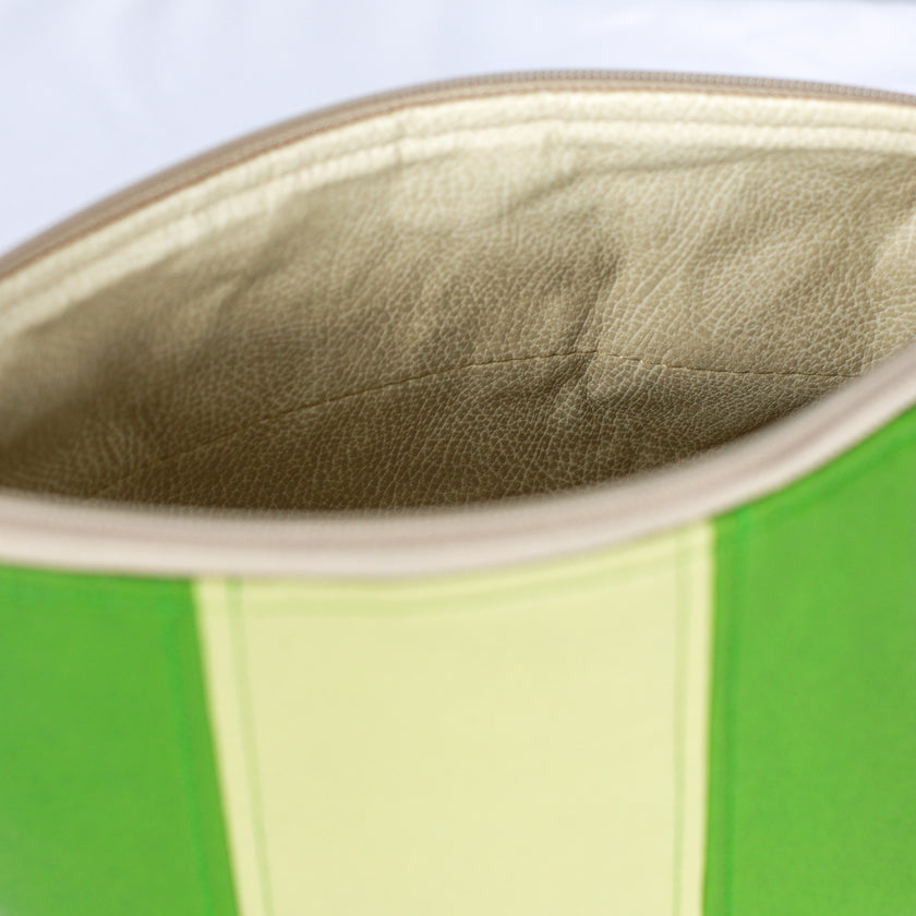 A cream luxury leather alternative fabric on a green multi-panel makeup kit 