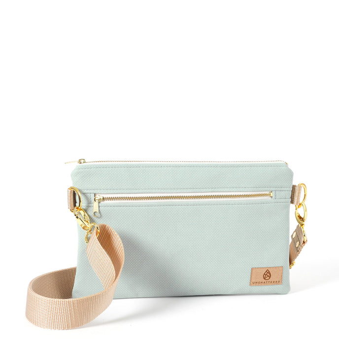 George 3-in-1 Bag handcrafted from light blue wipe-clean material with a beige crossbody strap on a white background 