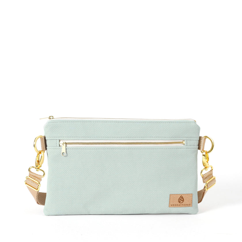 George 3-in-1 Bag handcrafted from light blue wipe-clean material with a beige belt bag strap 