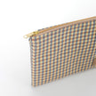 Gold-tone zipper on checked Kara Zip Pouch by Unshattered