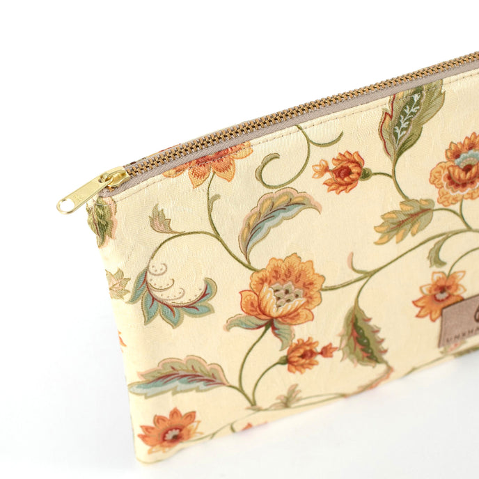 Gold-tone zipper on an Unshattered zip pouch handcrafted from upcycled floral material