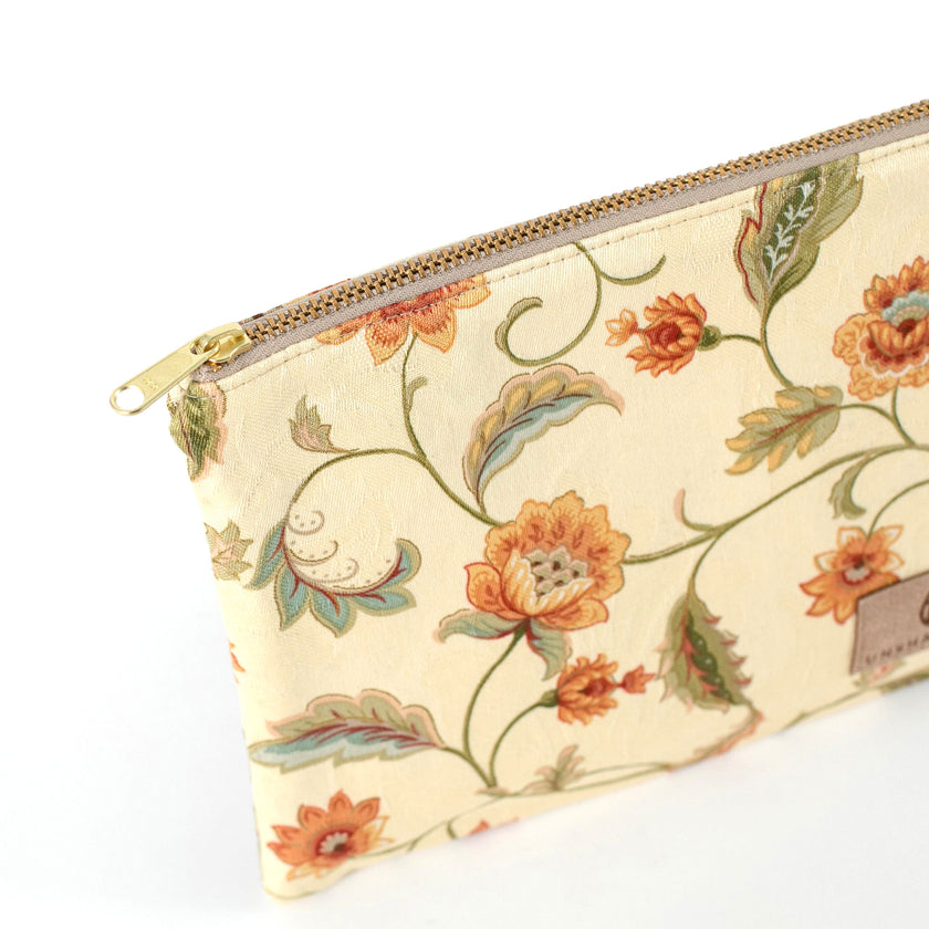 Gold-tone zipper on an Unshattered zip pouch handcrafted from upcycled floral material