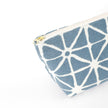 Gold-tone zipper on a blue geometric patterned makeup bag named Erin on a white background