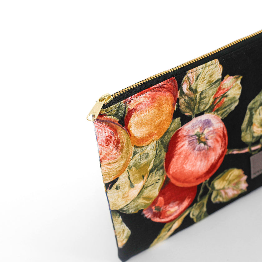Gold-tone zipper on an upcycled floral-patterned fabric pouch with apples named Gloryann 