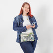 Person wearing a denim jacket and holding a zebra patterned bag with a plain background named after Chivon 