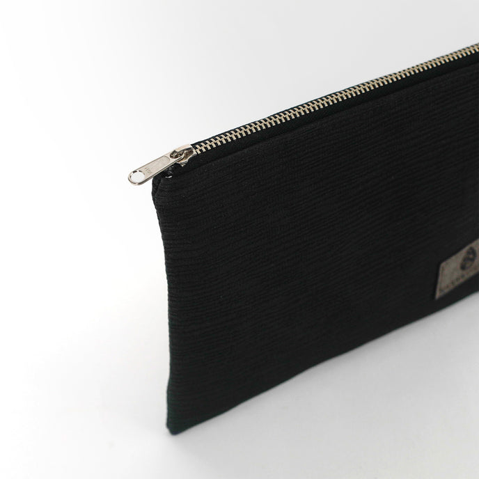 Black zippered pouch on a white background named after Harmony 
