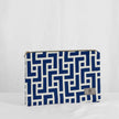 A large zip pouch with a blue and white geometric pattern and gold-tone hardware, displayed against a white background.