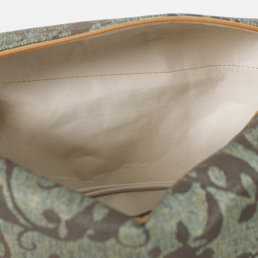 Close-up of a cream interior fabric toiletry with floral patterned fabric visible.