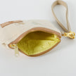 A yellow interior fabric on a monkey and tree clip pouch with a tan strap and gold tone zipper named after Jane 