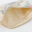 A shiny cream fabric interior on this floral large zip pouch 