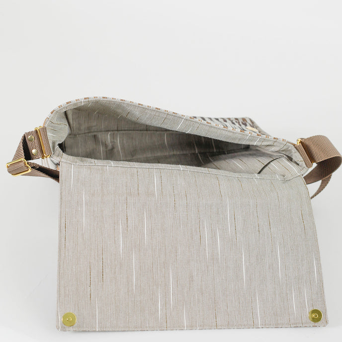  A beige striped interior fabric on mocha designed classic messenger bag named after Chelsea 