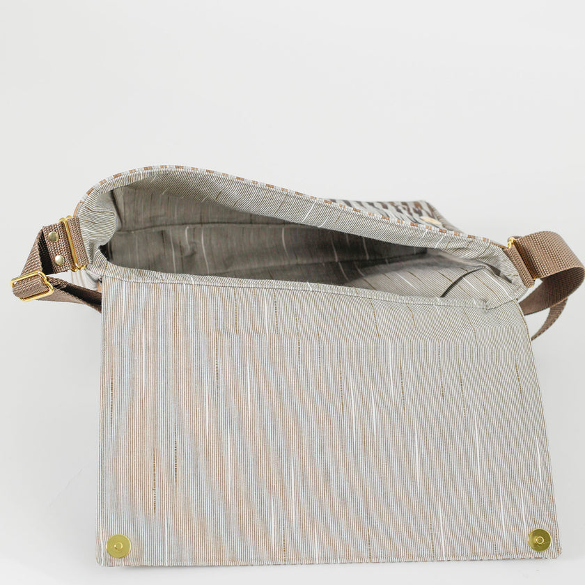  A beige striped interior fabric on mocha designed classic messenger bag named after Chelsea 