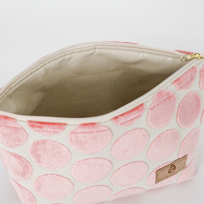 Cosmetic bag with pink polka dot  pattern with a beige interior 