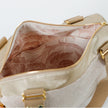 A pink floral interior on a pink and white exterior handbag named after Hayley